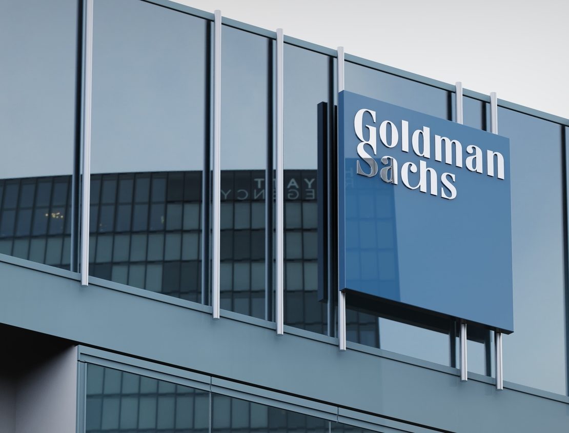 Business professionals overlooking a city financial district as global M&A activity rebounds amid heightened regulatory scrutiny and transaction complexity.