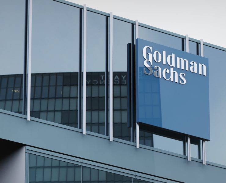 Business professionals overlooking a city financial district as global M&A activity rebounds amid heightened regulatory scrutiny and transaction complexity.