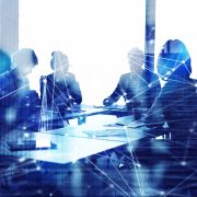 Corporate legal professionals reviewing business strategy and AI governance initiatives in a modern boardroom.