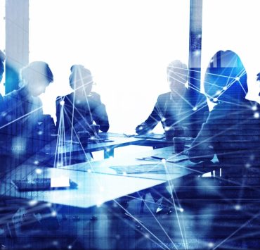 Corporate legal professionals reviewing business strategy and AI governance initiatives in a modern boardroom.