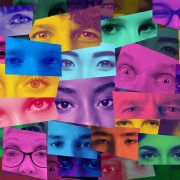 an artistic collage of human eyes and faces representing global diversity